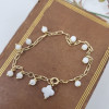 Bracelet dizainier de 10 perles et croix nacre sur chaine plaqué or